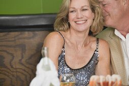 Mature man embracing woman in restaurant