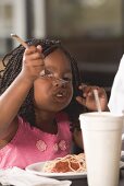 Girl eating spaghetti with mince sauce