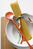 Spaghetti with Italian ribbon and cooking spoon