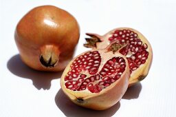 Pomegranates, whole and halved