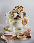 Vanilla ice cream with nuts and raisins in a sundae glass