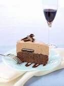 A piece of chocolate cake and a glass of red wine