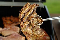 Lamb chop in grill tongs