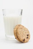 A glass of milk with two wholemeal biscuits