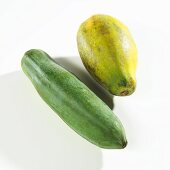 A green and a yellow papaya