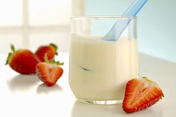 A glass of yoghurt and strawberries