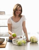 Woman with apples in kitchen