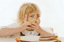 Little girl eating sandwich