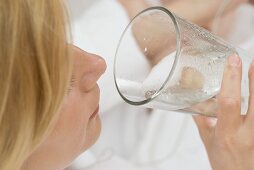 Woman drinking a glass of mineral water