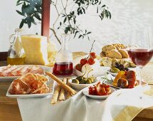 A table laid with antipasti and red wine