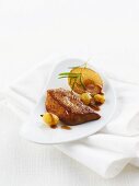 Fried foie gras with sliced apples, green grapes and rosemary