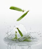 Pea pods falling into water