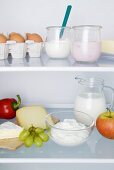A fridge filled with dairy products, eggs, fruit and vegetables