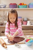 Girl cutting out biscuits