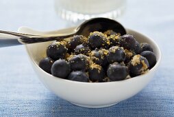 Blueberries sprinkled with cane sugar in a bowl