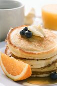 Pancakes with butter and fruit for breakfast