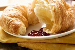 Croissant with jam on a plate