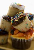 Colourful, decorated muffins in a pile