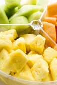 Pieces of fruit in a plastic bowl