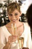 Young woman about to take a drink of champagne