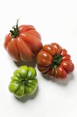 One green and two red beefsteak tomatoes