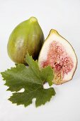 One whole and one half fig with leaf