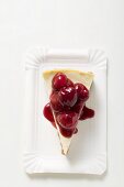 A piece of cheesecake with cherry sauce