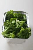 Steamed broccoli in an aluminium container