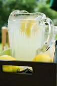 Lemonade in a glass jug with slices of lemon