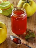 Quince jelly in a jar and on a spoon