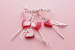 Four heart-shaped lollipops with bow