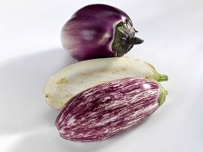 Whole and halved aubergines