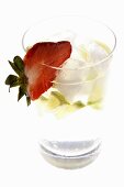 Mineral water with lime wedges, ice cubes and strawberry