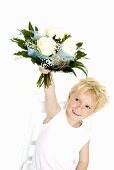 Blond boy holding bouquet of white roses