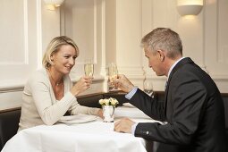Married couple raising glasses of sparkling wine