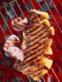 Sirloin steak with onions on a barbecue