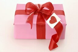 Gift with red bow and heart