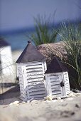 Two windlights by the sea with marram grass