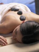 Woman having a warm stone massage