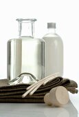 Scented oil in bottle on towels
