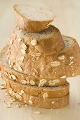 Slices of oat bread in a pile on a wooden table