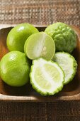 Kaffir limes and limes in wooden bowl