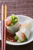 Vietnamese spring rolls with asparagus, shrimps, chili sauce