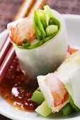 Vietnamese spring rolls with asparagus, shrimps, chili sauce