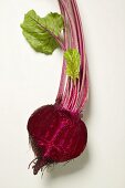 Beetroot with leaves, halved