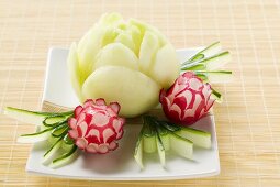 Large and small radish flowers with carved cucumber