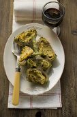 Stuffed artichokes with gratin topping, glass of red wine