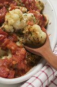 Cauliflower and tomato bake (detail with wooden spoon)