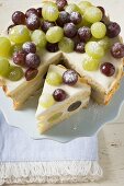 Grape cake, a slice cut, on cake stand