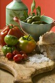 Fresh tomatoes, olives, bread, salt and olive oil
